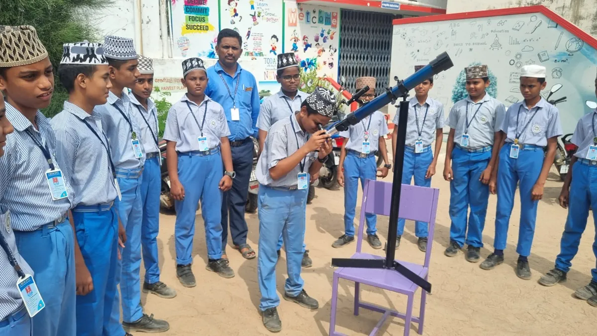Students observing the sky through a telescope during a science activity