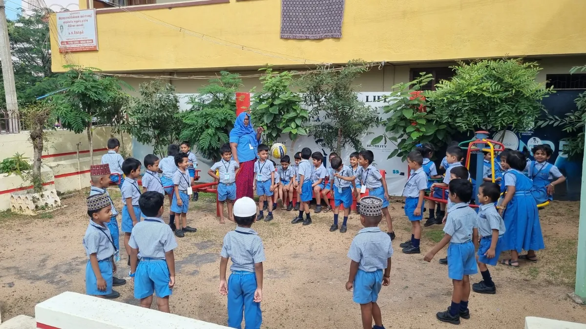 Kindergarten children taking part in an outdoor group activity