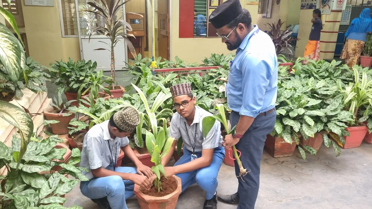 Students planting a sapling with their teacher on the campus